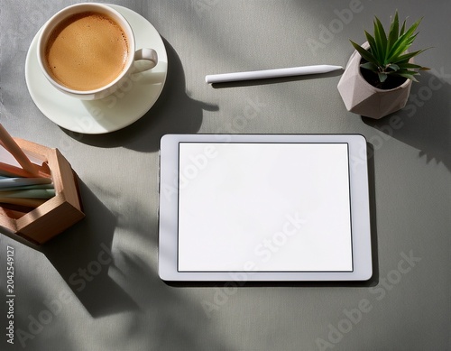 minimalist workspace with coffee tablet and writing materials