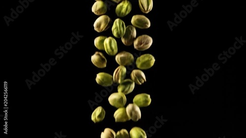 Pistachios falling in slow motion on a black background healthy snack concept