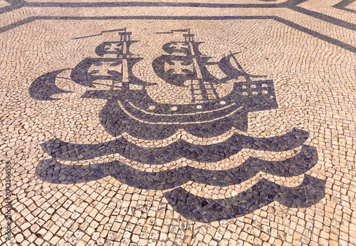 Bild auf Leinwand Portuguese Caravel Mosaic on Traditional Pavement in Lisbon Portugal