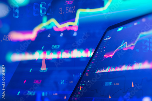 Colorful trading charts on digital screen showing financial data, stock prices, candlestick bars and market analytics dashboard for investment, forex, crypto and fintech business concept.