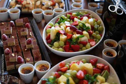 Obraz na plátně Gourmet buffet: chocolate petit fours, fresh fruit salad, crème brûlée