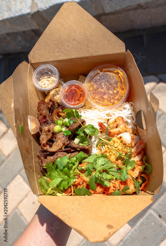 Bun thit nuong or grilled pork, shrimps with vermicelli, Vietnamese cuisine. Pork is marinated well and grilled on char coal stove, eat along with shrimps, spring rolls, sour and sweet fish sauce.