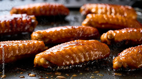 cooking chicken wings in a grill, selective focus. chicken wings roasting on a grill selective focus.