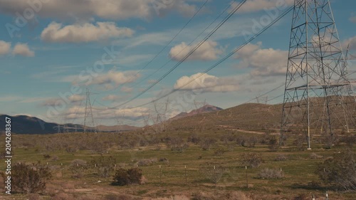 High voltage power lines over desert landscape