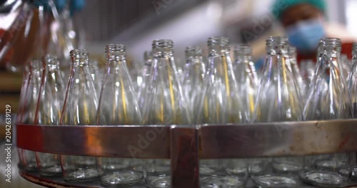At beverage bottles line, focused workers systematically organizes the bottles into a large container. then staged at the loading dock, ready for distribution in beverage drinking water factory