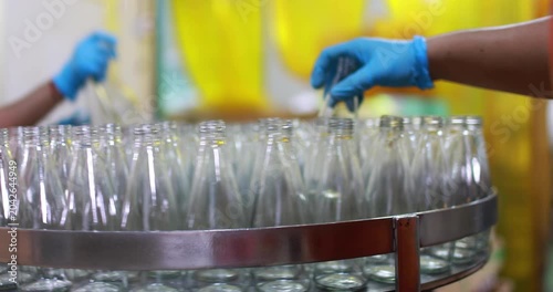 At beverage bottles line, focused workers systematically organizes the bottles into a large container. then staged at the loading dock, ready for distribution in beverage drinking water factory