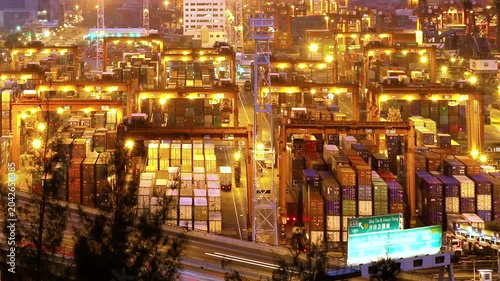 Cargo terminal port timelapse in Hong Kong of China. Busy cargo container loading activities. Rush hour road and traffic. Beautiful vibrant city vibe.