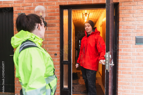 Technician Greeting Homeowner at Entrance for Service Appointment