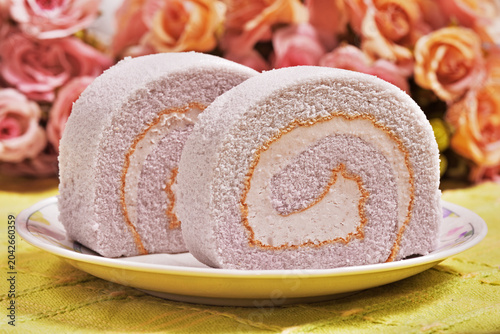 Slice of taro swiss roll on the plate   