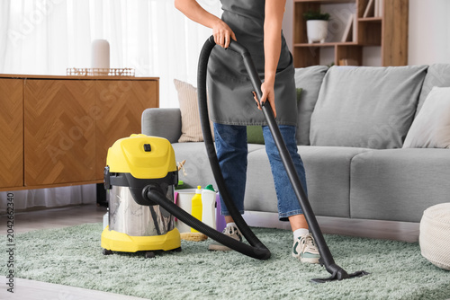 Young woman with vacuum cle...