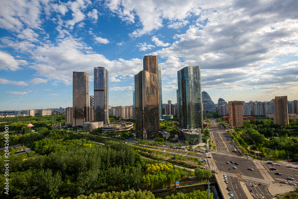 Obraz premium Wangjing CBD urban high-rises and lush greenery landscape, Beijing, China.