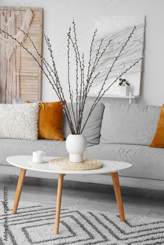 Vase with willow branches a...