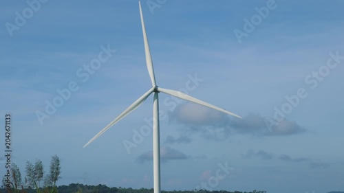Aerial view of powerful Wind turbine farm for energy production on beautiful cloudy sky at highland. Wind power turbines generating clean renewable energy for sustainable development green energy.