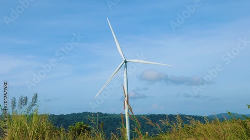 Aerial view of powerful Wind turbine farm for energy production on beautiful cloudy sky at highland. Wind power turbines generating clean renewable energy for sustainable development green energy.