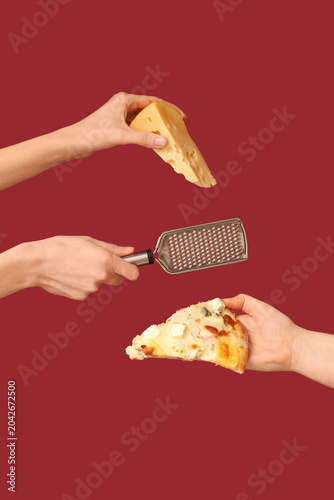 Many hands holding pizza sl...