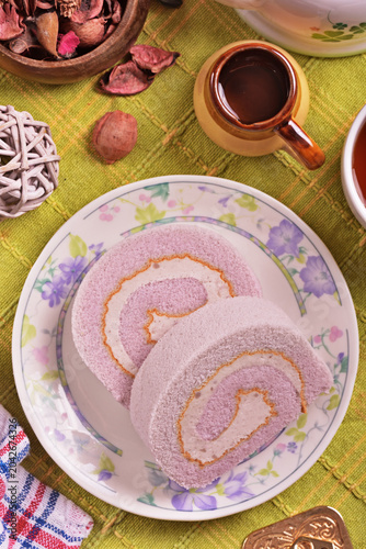 Slice of taro swiss roll on the plate   