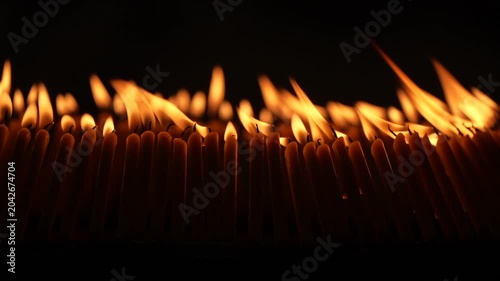 Rows of warm candle flames in a dark temple setting create a sacred visual composition with glowing light, soft smoke, and peaceful Buddhist worship atmosphere.