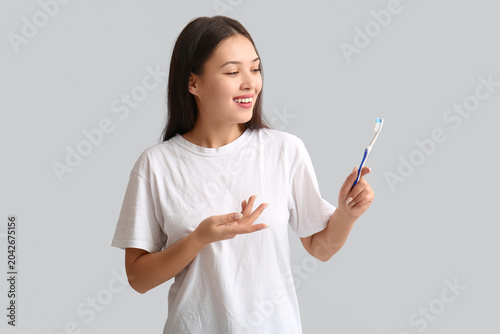Young Asian woman with toot...
