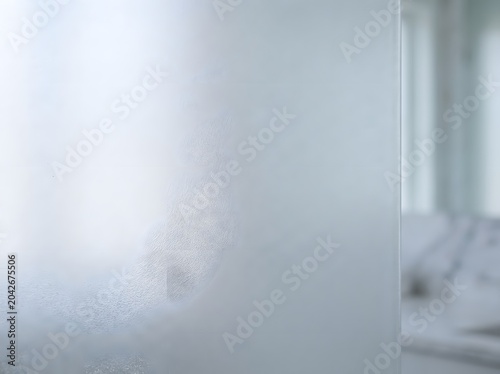 Detailed surface of frosted glass panel showcasing intricate texture and soft light diffusion for modern interior design
