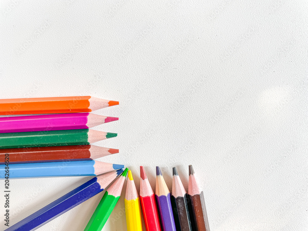 Fototapeta premium Colorful pencils corner arrangement with copy space white background education creativity