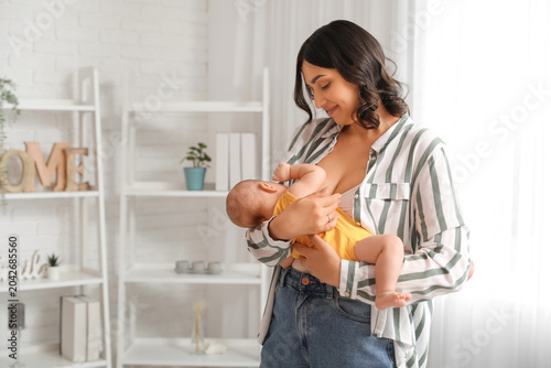 Young woman breastfeeding h...