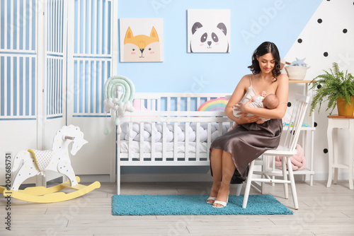 Young woman breastfeeding h...