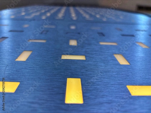Blue metal surface with elegant yellow light box pattern