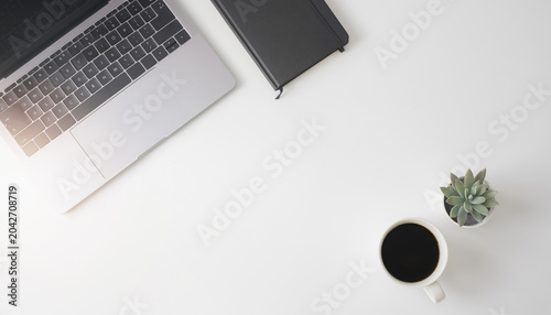 Konstfotografi Minimal modern office desk flat lay with laptop notebook coffee and plant on whi