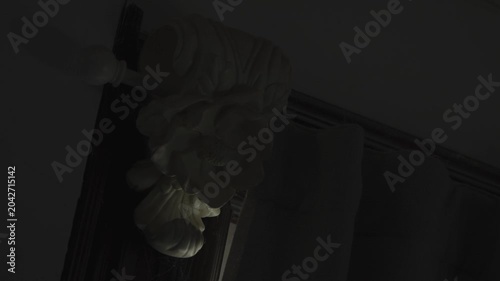 Spooky supernatural light illuminating the corner of a dark, creepy haunted house. Halloween background.
