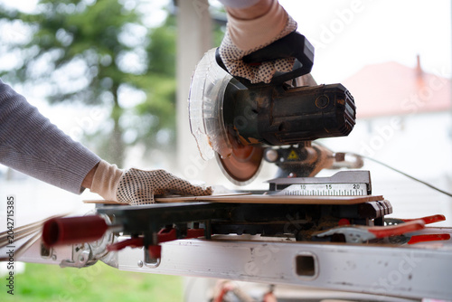 Woodworking process with a power saw at a job site