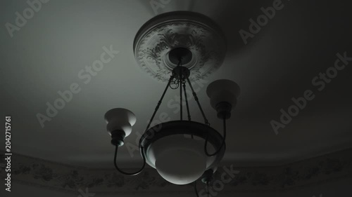 Ominous supernatural light gliding through a haunted house. Spooky Halloween background.