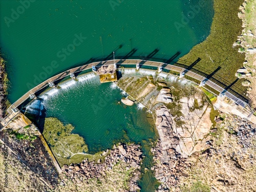 A top-down aerial view of a dam wall and river out at the beardy waters, Glen Innes, NSW, Australia