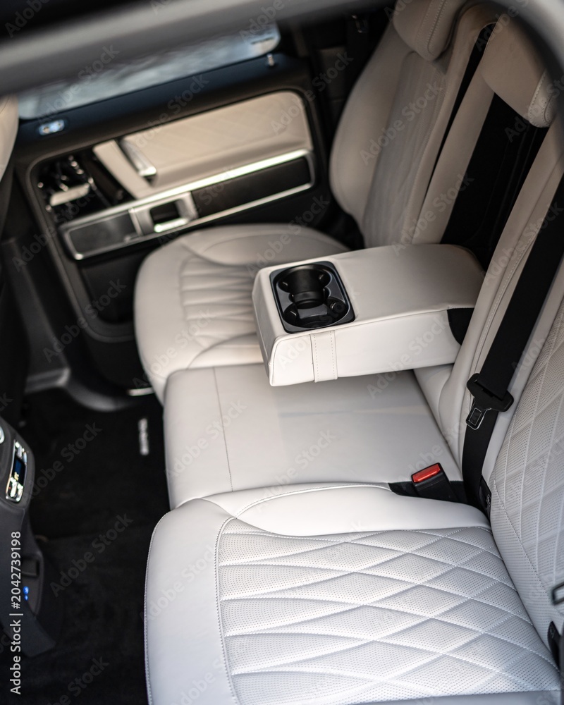Naklejka premium Luxurious Car Interior With Quilted Leather Seats and Center Console.