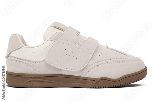Cream colored casual shoes without laces with brown soles isolated on white background