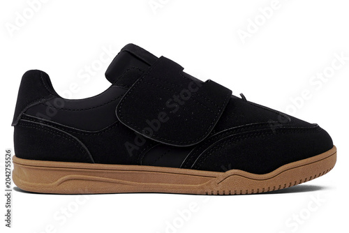 Black casual shoes without laces with brown soles isolated on white background