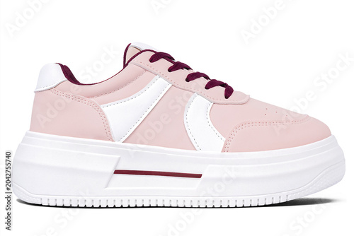 Casual shoes in a combination of salmon pink and white with thick white soles isolated on a white background