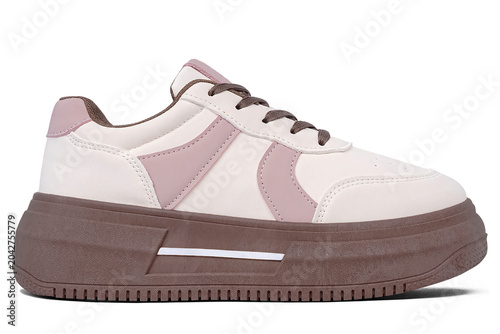Casual shoes in a combination of cream and soft purple with thick brown soles isolated on a white background