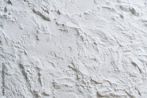 White textured plaster wall featuring rough mineral peaks in a sharp macro shot for architectural and interior design branding