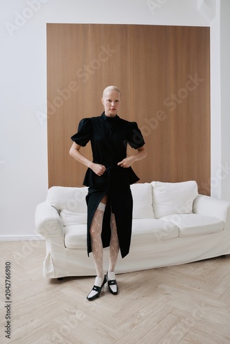 Luxury fashion portrait woman pose before white sofa