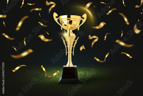Cuadro en lienzo Golden trophy stands on a pedestal with confetti around it