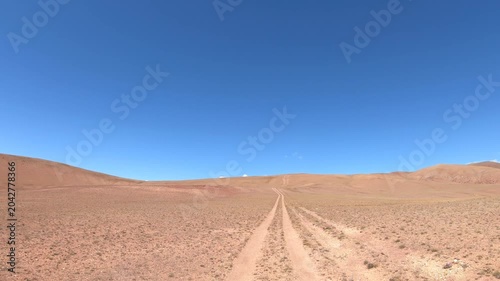 Driving along a country road in Altai desert and semi-desert environment.