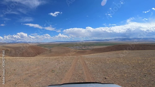 Driving along a country road in Altai desert and semi-desert environment.