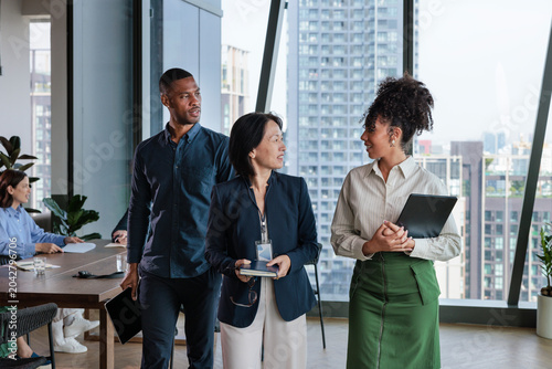 Diverse business team in modern office with city view.