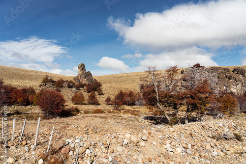 Rocks, grass, and blue sky in this Patagonina landscape
