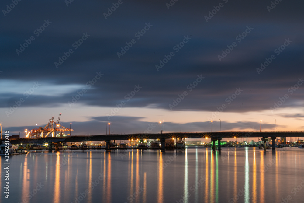 Naklejka premium Tauranga Harbour Bridge lights and reflections before sunrise