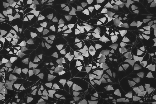 Black and white floral fabric pattern with delicate leaf motif background