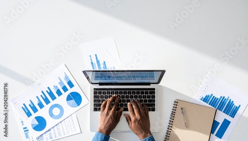 Laptop user analyzing charts with business data visualization overlay