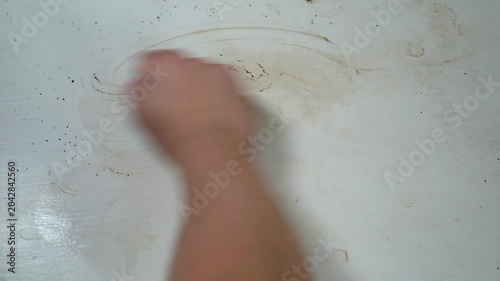 Male hand wipes a white table with a white towel in close-up. Cleaning services. Home cleaning. 