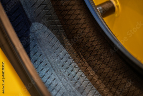 Close-up of the textured inner liner of a cutaway car tire on display