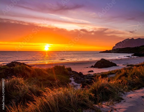 Stunning coastal sunset with vibrant colors over ocean beach landscape